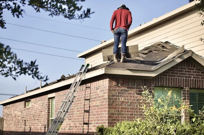Professional roofer working on a residential roof in Wright City